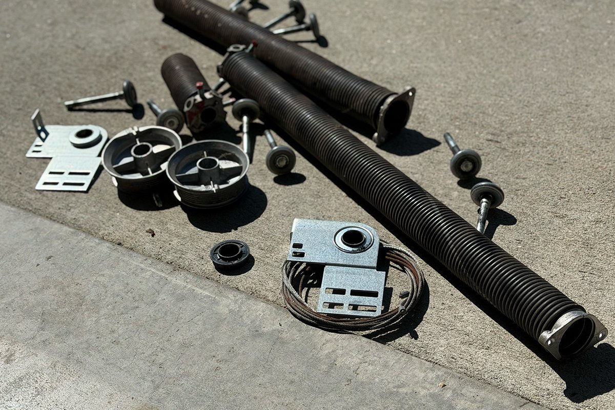 Broken garage door parts removed during repair in Little Rock AR